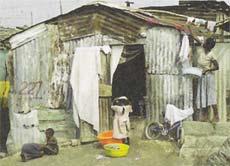 Gladys wohnt mit ihrer Familie in dieser Wellblechhütte.